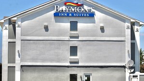 A Baymont Inn & Suites building with a simple, modern design, featuring a prominent sign at the top. - Baymont by Wyndham Anderson (Anderson)