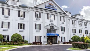 A large, white building with a sign reading "Baymont Inn & Suites".