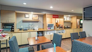 A modern kitchen with built-in appliances, a breakfast bar, and seating for guests. - Towneplace Suites By Marriott Streetsboro (Streetsboro)