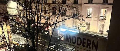 A view of a building with a sign that reads "MODERN HOTEL" in the foreground.