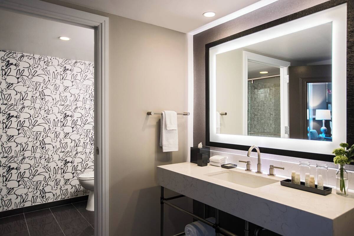 designer toiletries, hair dryer, towels, soap