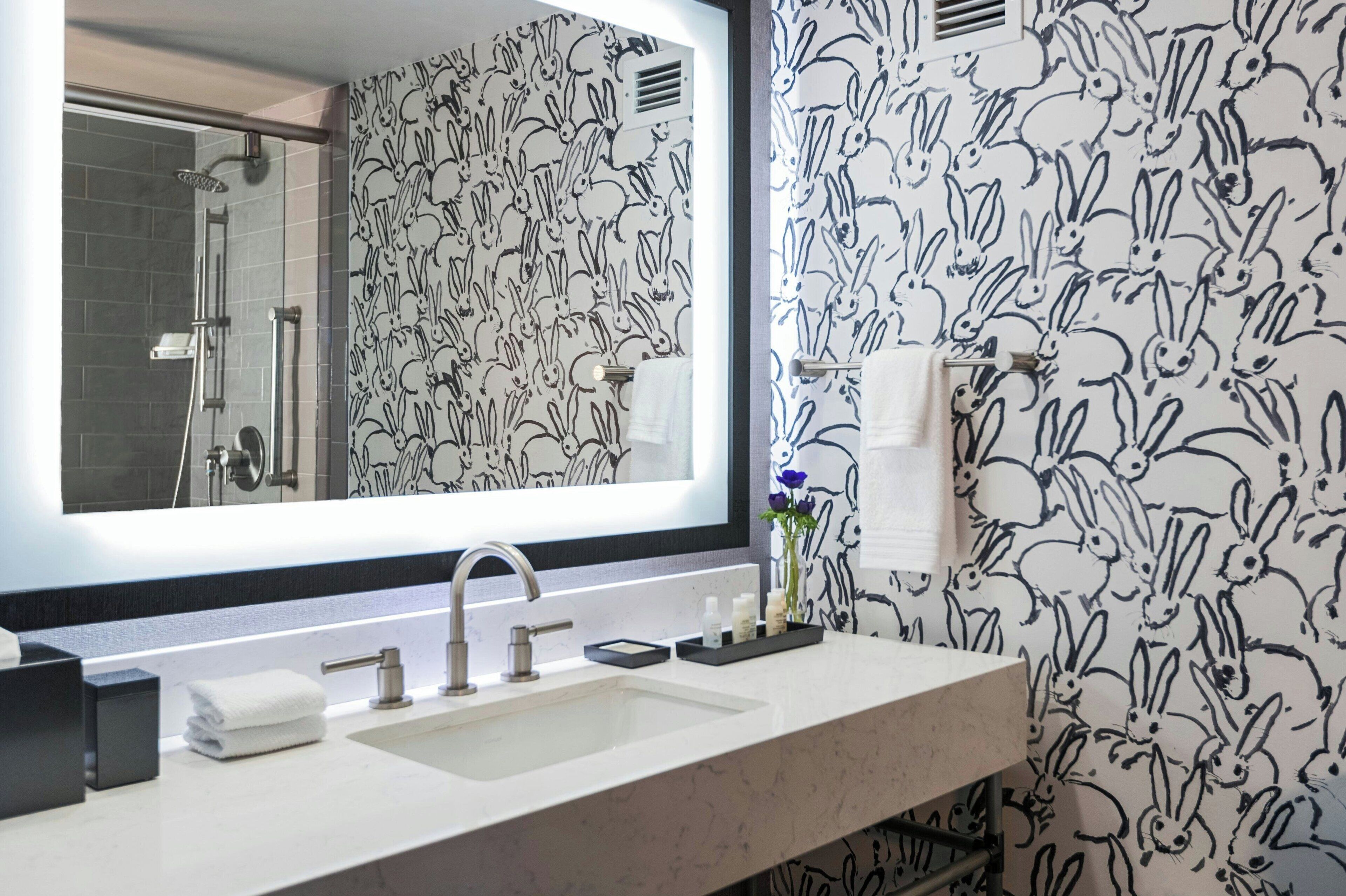 designer toiletries, hair dryer, towels, soap