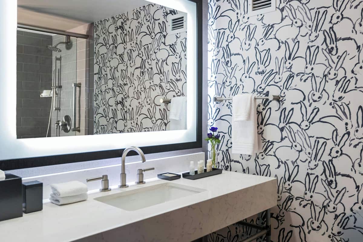 designer toiletries, hair dryer, towels, soap