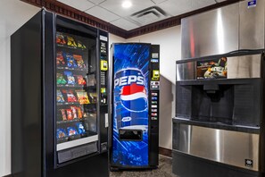 A vending machine with a Pepsi logo, a refrigerator, and a water dispenser. - Best Western Big Spring Lodge (Neosho)