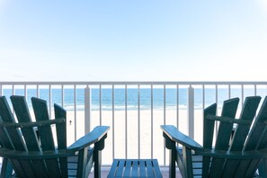 A balcony with two green Adirondack chairs facing a beach. - Comfort Inn Ocean City Boardwalk (Ocean City)