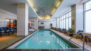 An indoor swimming pool with lounge chairs and a no diving sign. - Embassy Suites by Hilton Chicago Downtown Magnificent Mile (Chicago)