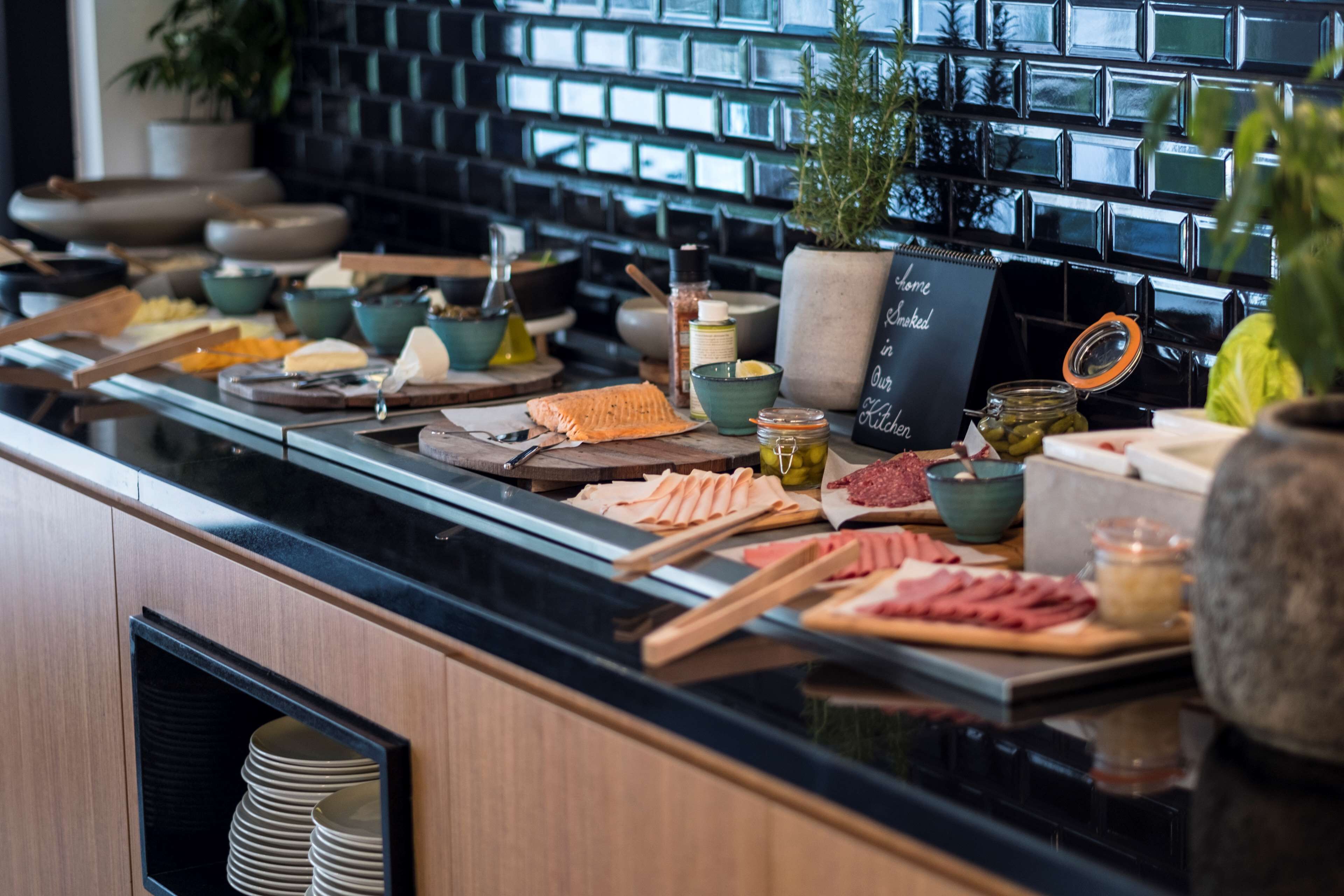 A buffet with various food items and condiments.