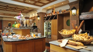 A breakfast buffet with various food items and beverages.