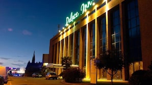 A hotel with a prominent sign reading "Palace Inn" and a large, modern building facade with multiple windows. - Palace Inn (Fiano Romano)