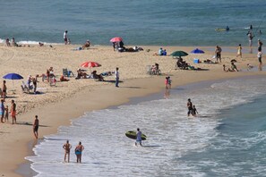 A beach with people walking, sitting, and sunbathing. - Harlington Ashkelon (Ashkelon)
