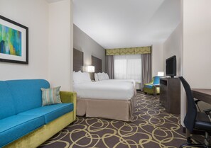A hotel room with a bed, a blue sofa, a desk, and a television. - Holiday Inn Express & Suites Ames by IHG (Ames)