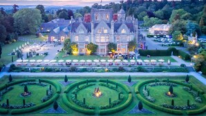 A large, historic building with a formal garden, manicured lawns, and a symmetrical layout. - De Vere Tortworth Court (Wotton-under-Edge)