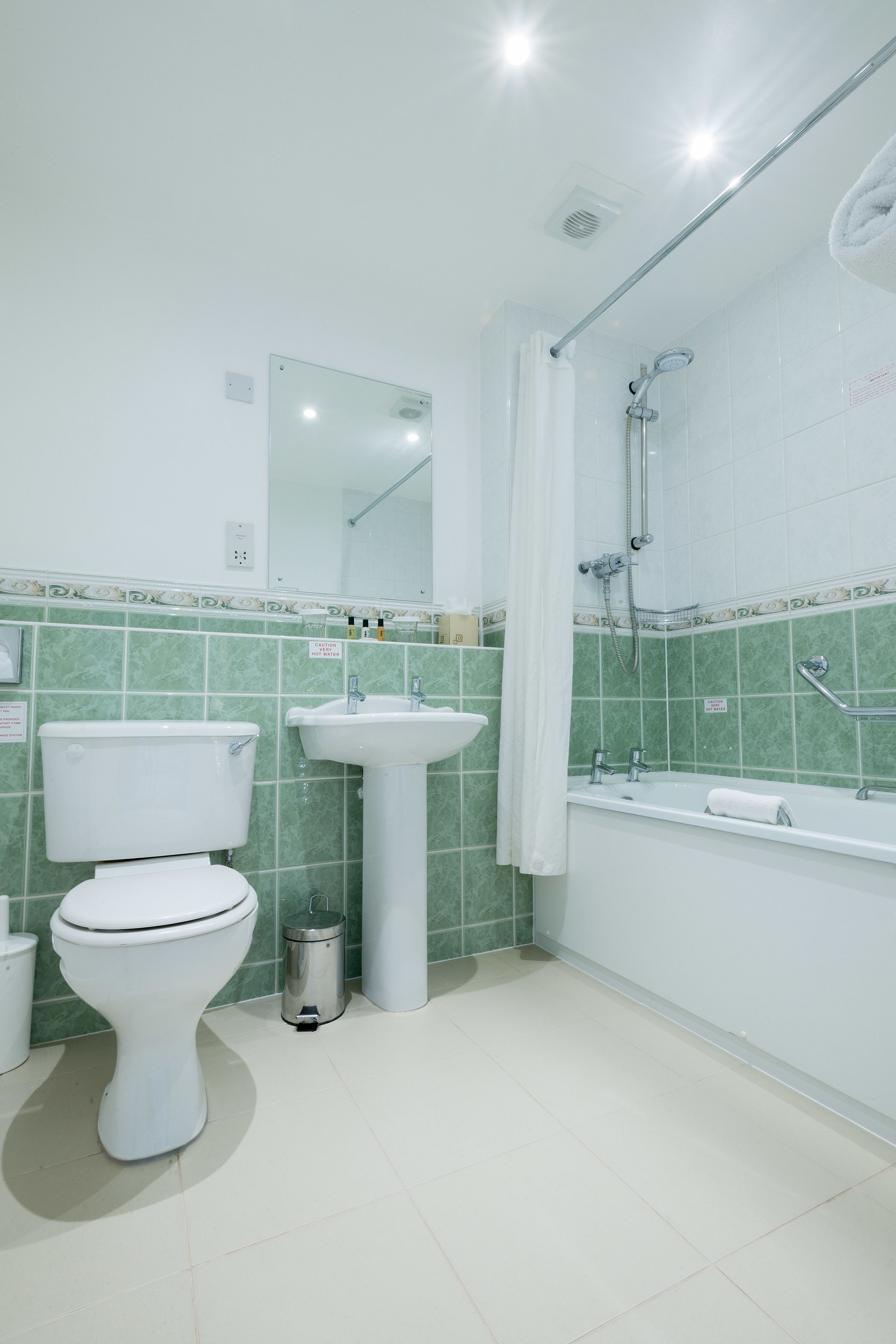 A bathroom with a toilet, sink, and bathtub.