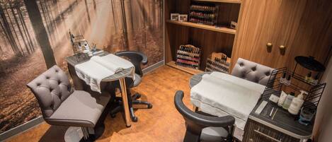 A room with two chairs, a table, and a shelf with nail polish.