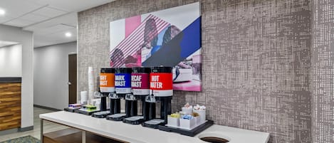 A coffee station with multiple dispensers labeled 'Light Roast,' 'Dark Roast,' 'Decaf,' and 'Hot Water.'