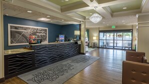 A reception area with a modern design, including a reception desk, a large framed picture, and a welcome mat. - Hampton Inn Eugene (Eugene)