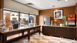 A modern kitchen with a checkered floor, a large window, and a refrigerator. - Hampton Inn Boston/Braintree (Braintree)