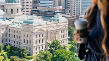 A large, historic building with a dome and classical architecture, surrounded by modern skyscrapers.