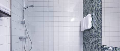 A modern bathroom with a shower, toilet, and sink.
