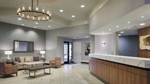A lobby with a reception desk, seating area, and a chandelier. - Residence Inn by Marriott Charlotte Uptown (Charlotte)