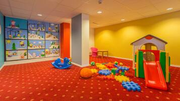 Children can play and explore in this vibrant play area with a colorful mural, building blocks, and a slide.