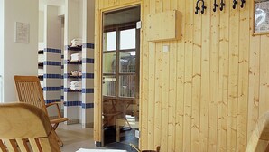 A wooden interior with two wooden chairs, a wooden cabinet, and a tiled floor. - Mercure Hotel & Residenz Checkpoint Charlie (Berlin)