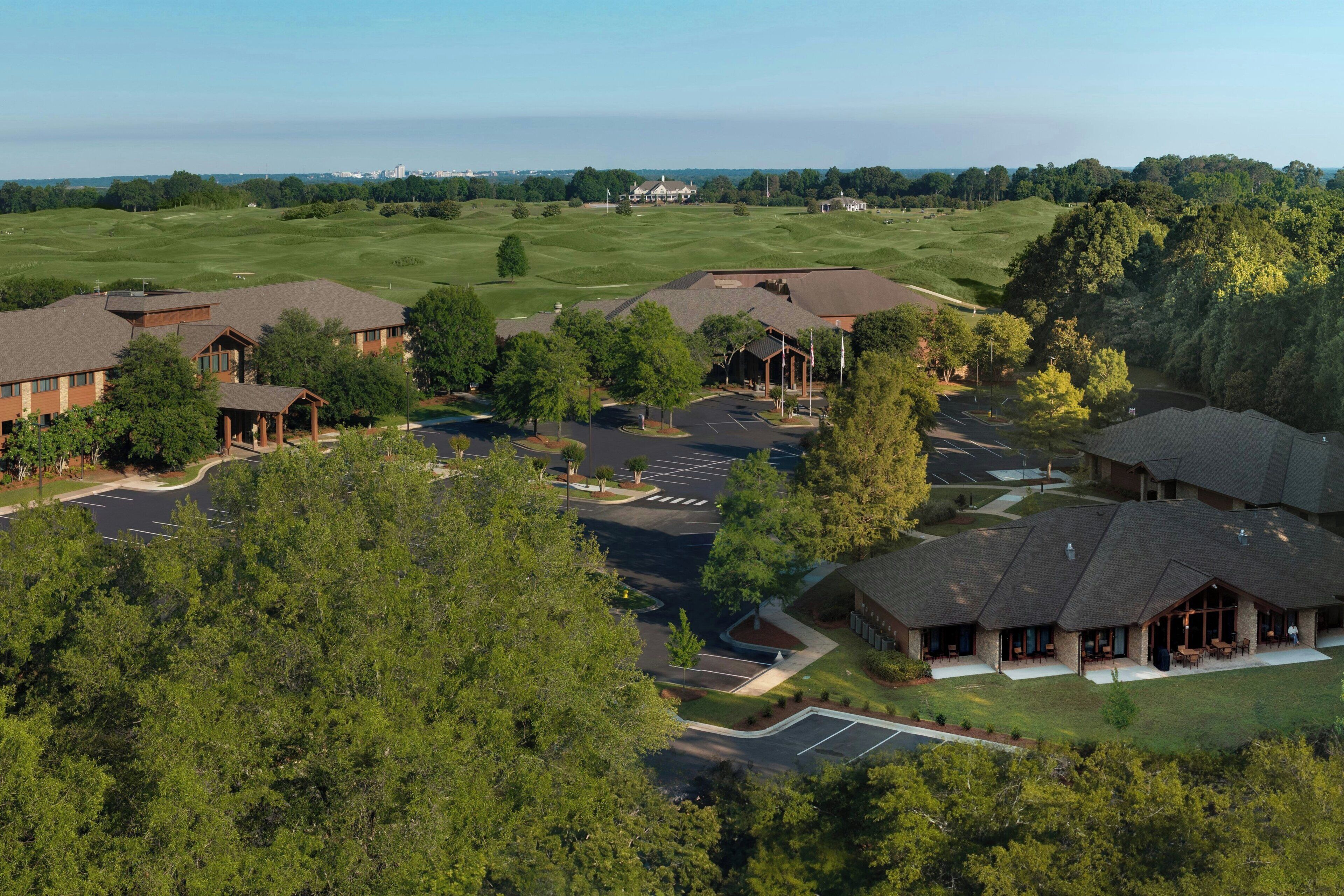 A golf course with buildings and parking areas.