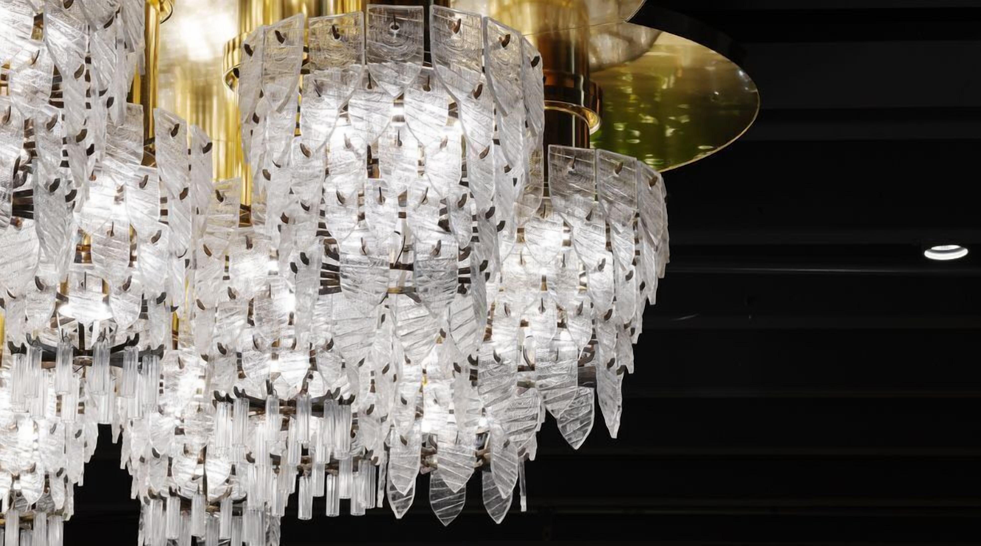 A chandelier with multiple tiers of clear, faceted glass elements.