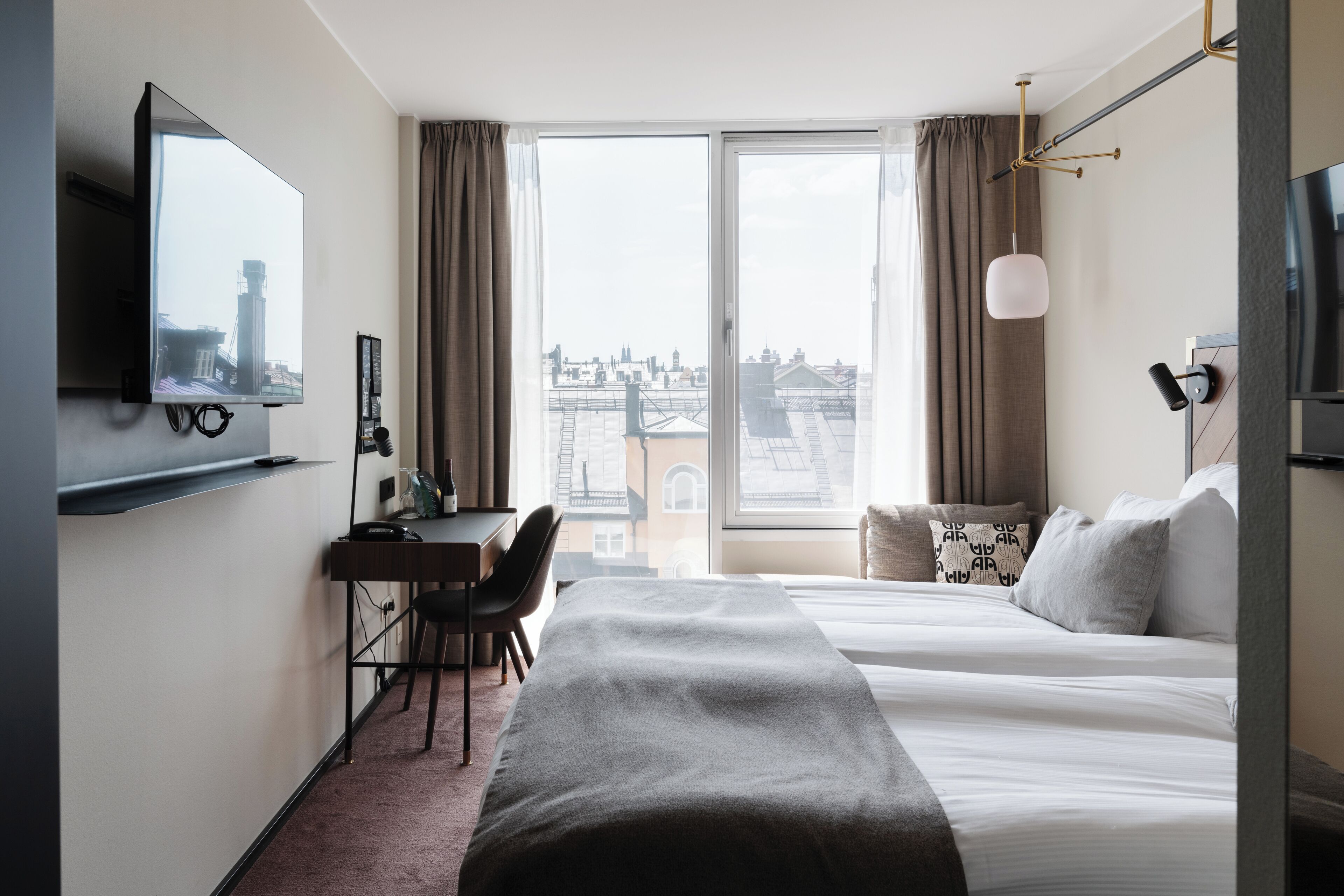 Desk, laptop workspace, iron/ironing board, bed sheets