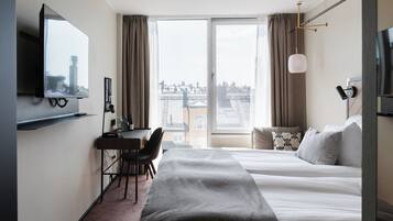Desk, laptop workspace, iron/ironing board, bed sheets
