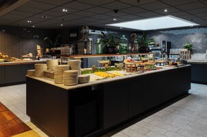 A buffet area with various food items and a coffee station.