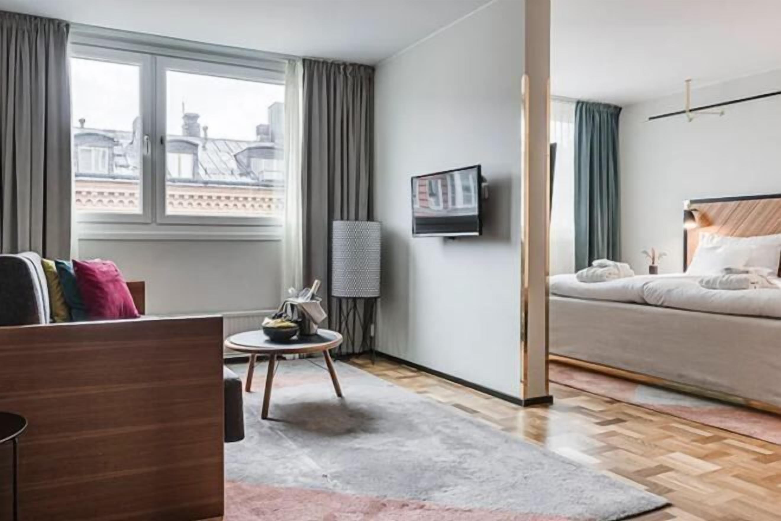 Desk, laptop workspace, iron/ironing board, bed sheets