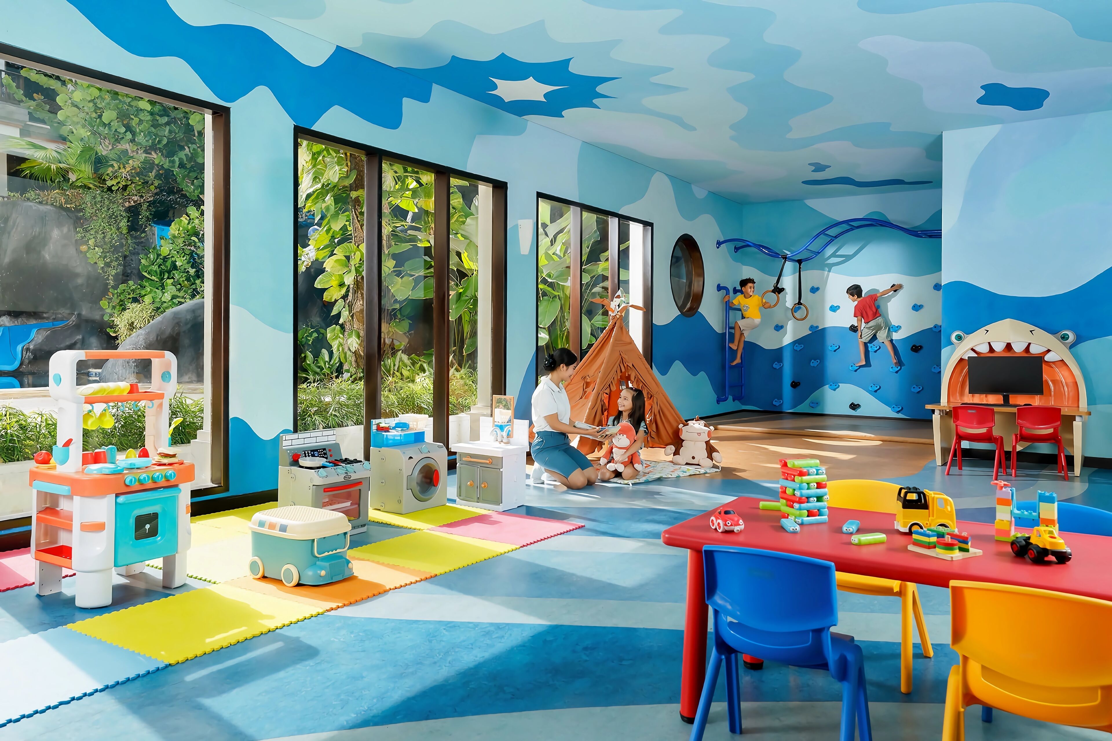 A children's playroom with colorful play mats, toys, and a tent.