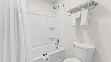 A bathroom with a shower, a toilet, and a towel rack.