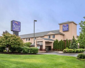 A Sleep Inn hotel with a modern design, featuring a prominent entrance and signage.