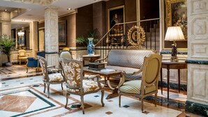 A lobby with ornate furniture, a staircase, and a large painting. - Relais & Châteaux Hotel Orfila (Madrid)