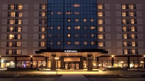 A multi-story hotel with a prominent 'HYATT REGENCY' sign, large windows, and a well-lit entrance. - Hyatt Regency Bishkek (Bishkek)