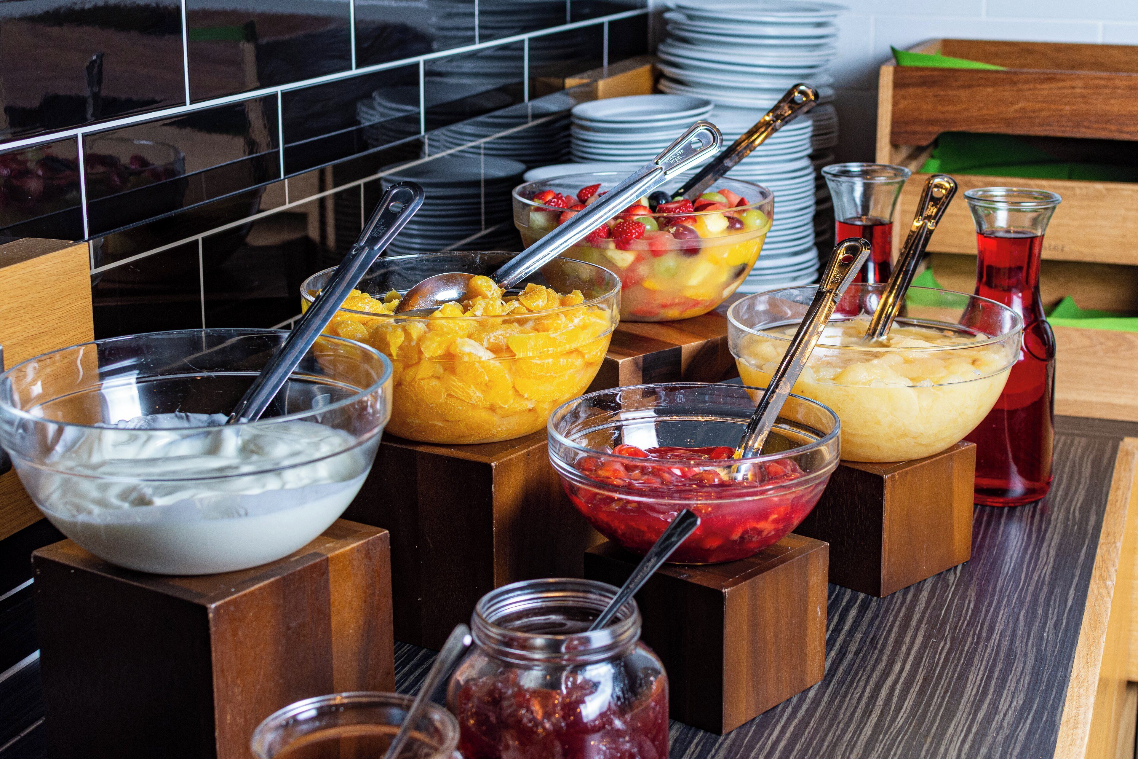 A buffet with various food items and utensils.