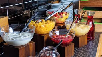 A buffet with various food items and utensils.