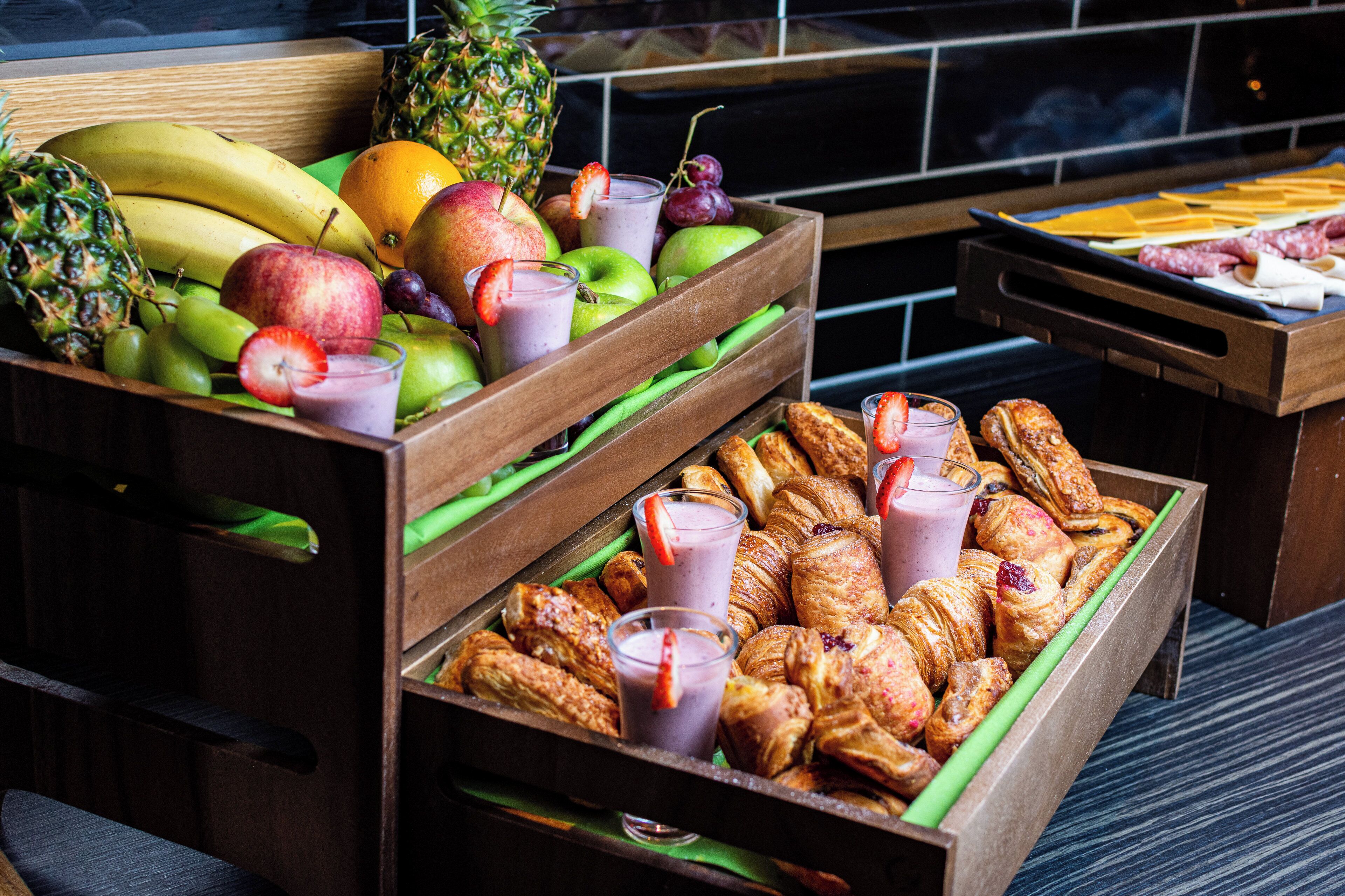A fruit and pastry display with various fruits and pastries.