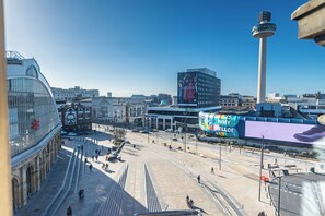 A cityscape with a prominent tower, a large billboard, and a pedestrian area with steps leading up to a building. - Holiday Inn Liverpool City Centre by IHG (Liverpool)