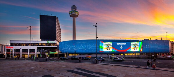 A cityscape with a prominent tower, a large digital billboard, and various commercial buildings. - Holiday Inn Liverpool City Centre by IHG (Liverpool)