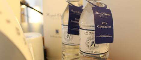 A bottle of water labeled "Royal Chalana" with a tag that reads "With Compliments."