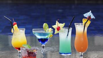 Five cocktails with various garnishes on a reflective surface.