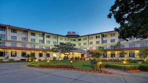 A hotel with a central courtyard, multiple floors, and a sign indicating it is a Ramada hotel.