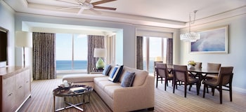 A spa room with multiple seating areas, a reception desk, and a large mirror. at The Ritz-Carlton Key Biscayne, Miami