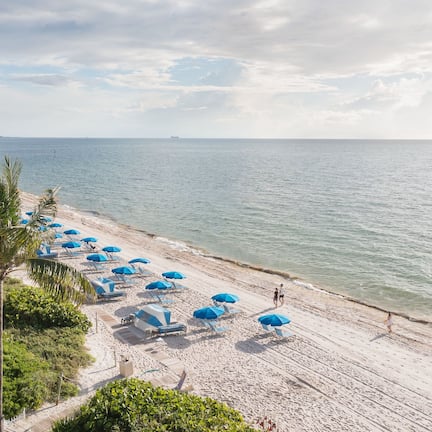 On the beach, white sand, beach cabanas, sun loungers