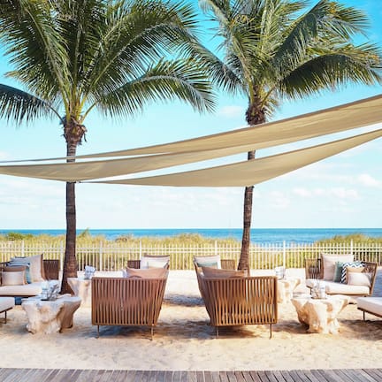 On the beach, white sand, beach cabanas, sun loungers