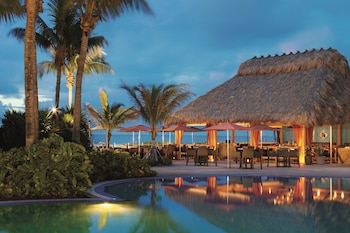 On the beach, beach cabanas, sun loungers, beach umbrellas at The Ritz-Carlton Key Biscayne, Miami