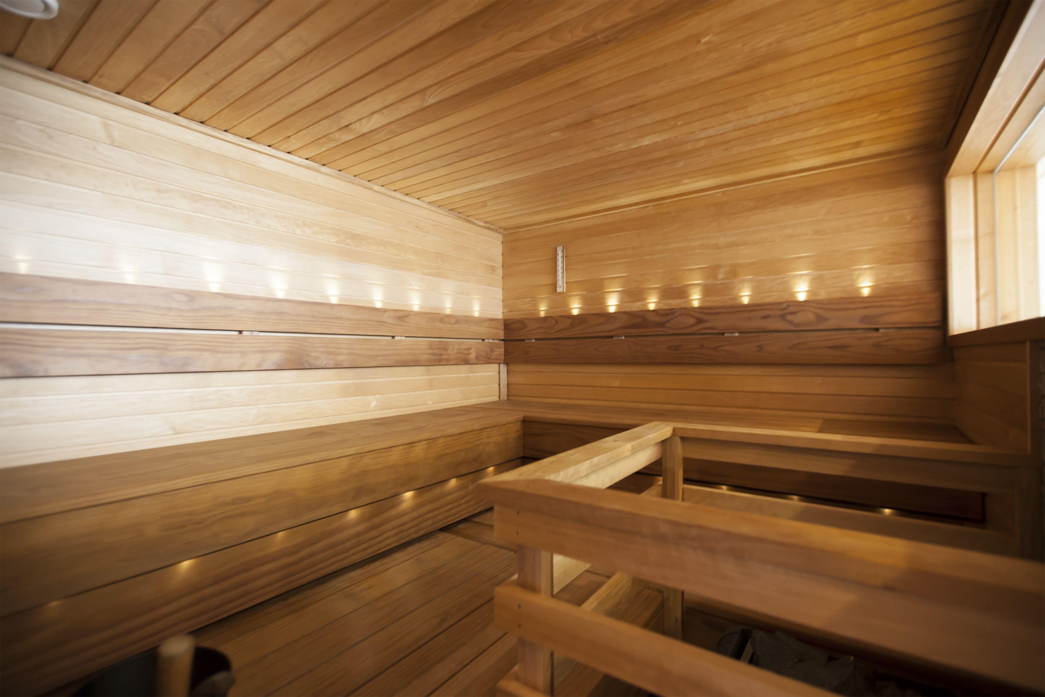 A sauna with wooden walls and benches.